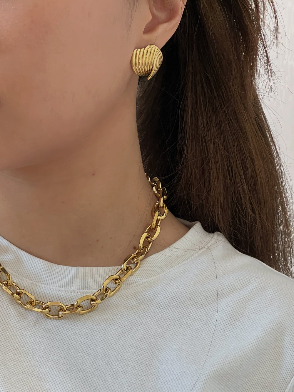 Stylish shell overlap design gold earrings, fashionable and modern wore by a woman