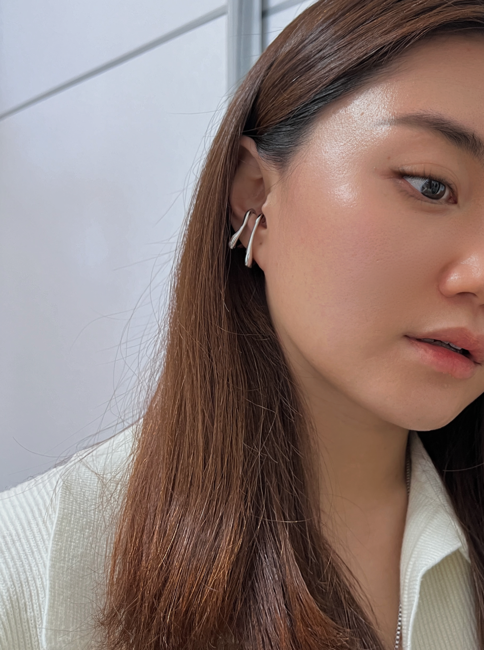 Artistic silver ear cuffs with a unique, fluid design.