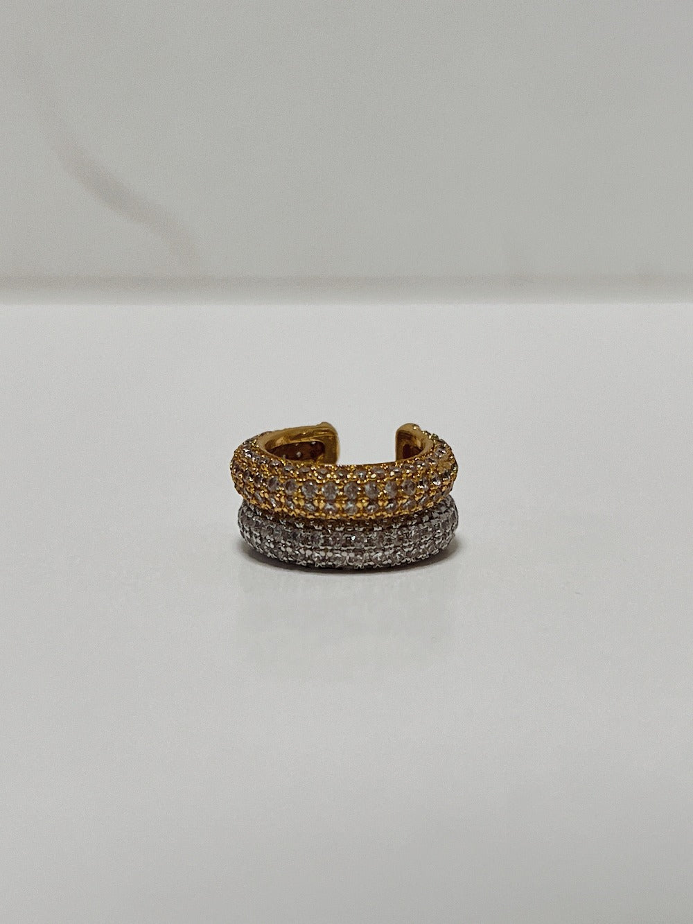 Macro shot of pavé light refraction of anika pave ear cuff.