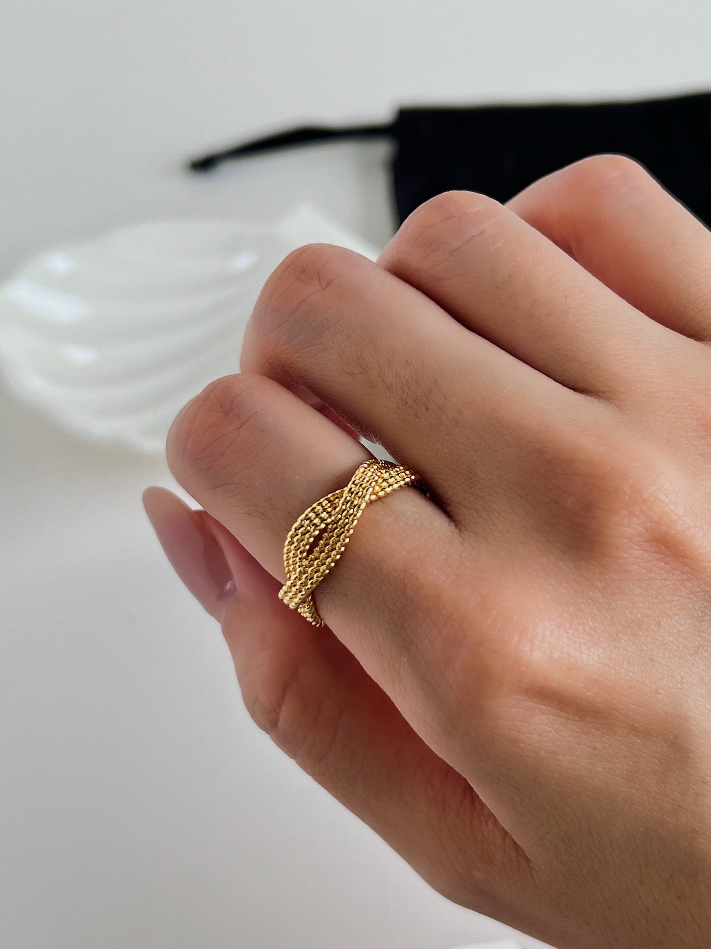 Chic modern jewelry featuring a gold braided ring Paris fashion