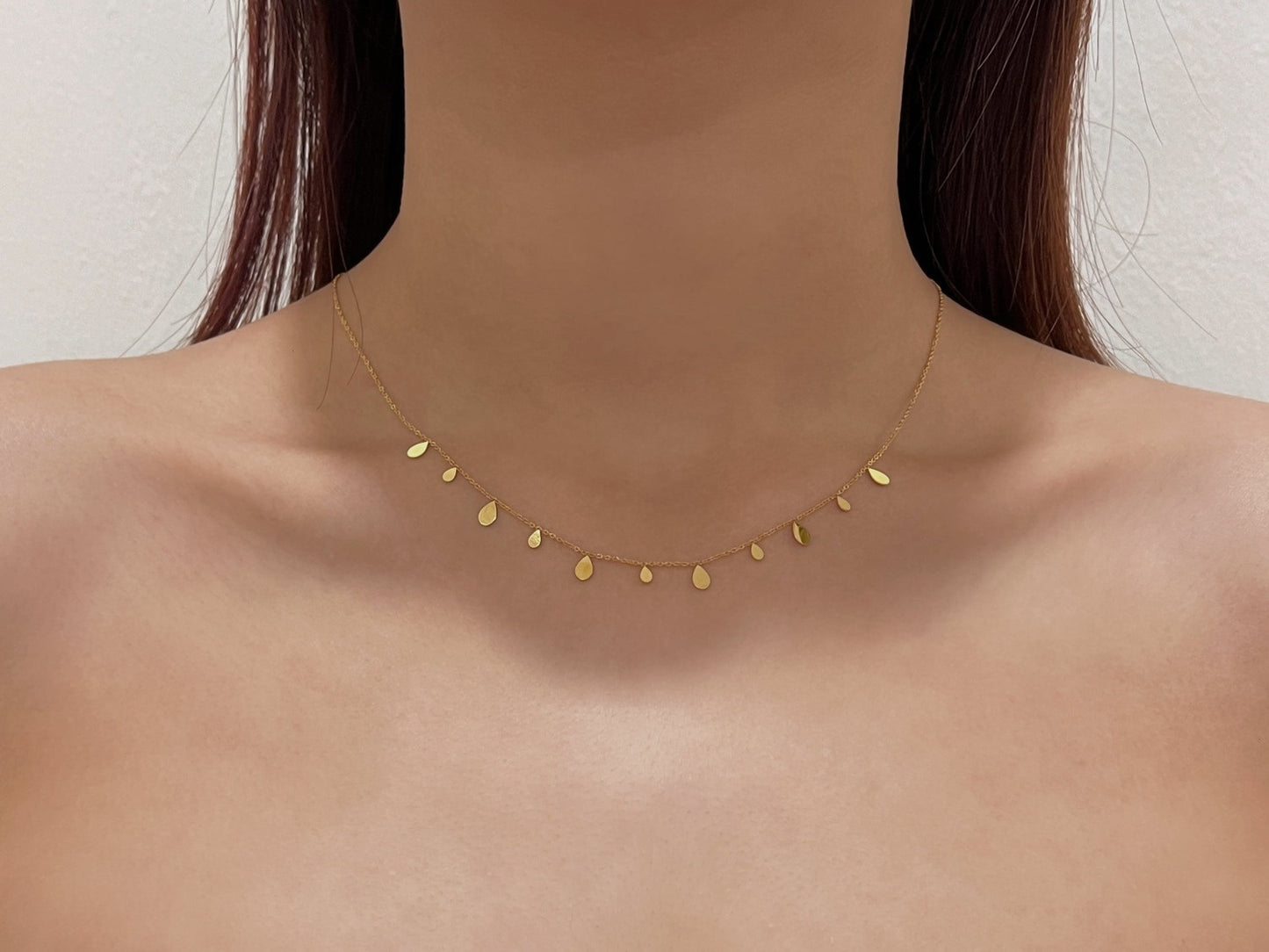 Sophisticated neck perspective view showing how a teardrop molten charm hangs vertically on body