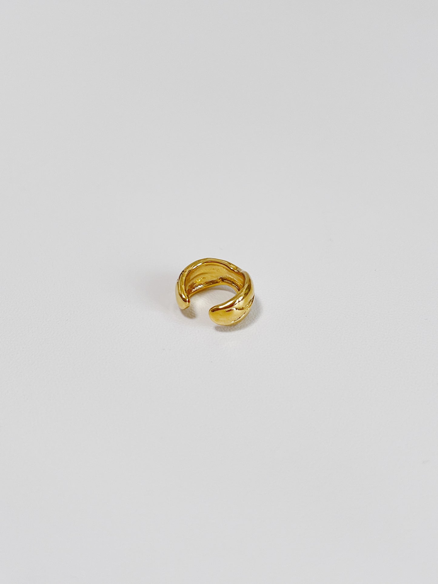 Detailed view of the PVD gold finish on the interior of the lyon brass ear cuff.