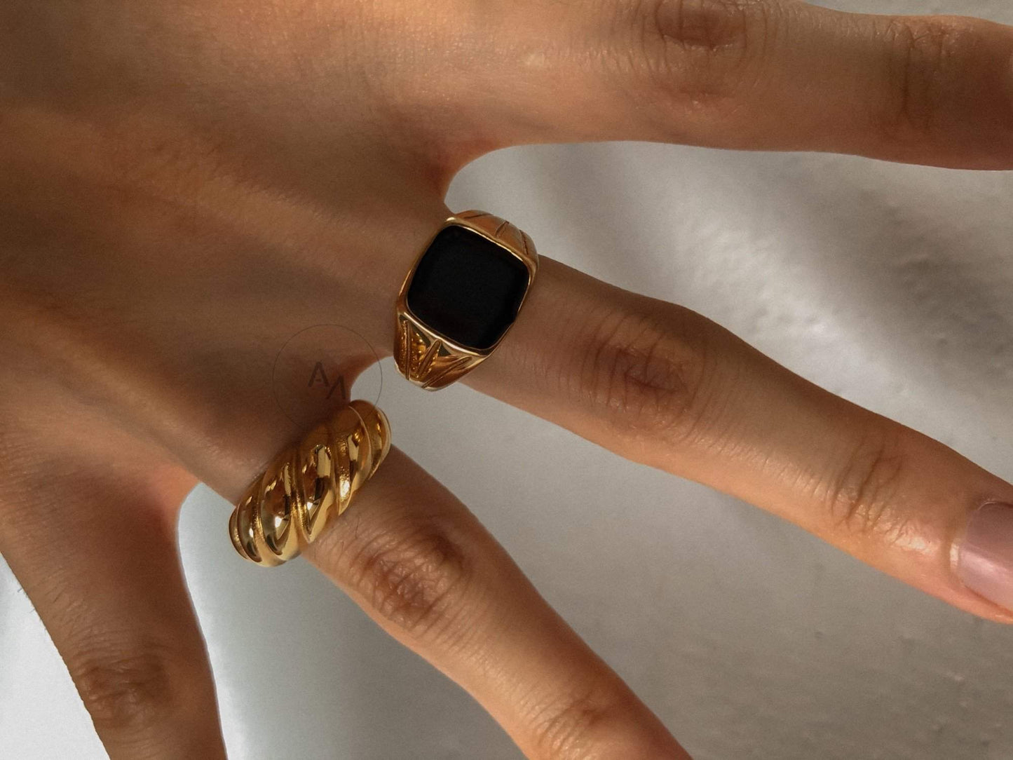 Gold ring with black gemstone, premium men's accessory for weddings and events