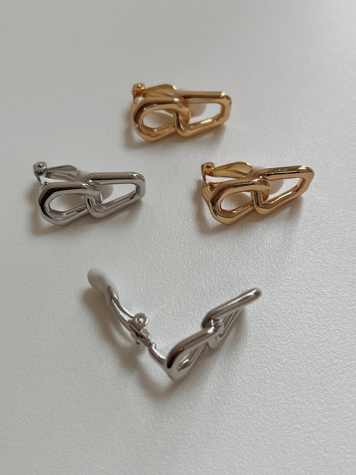 Side profile displaying the solid-cast structure and substantial balance of 40mm drop link clip-on earrings.