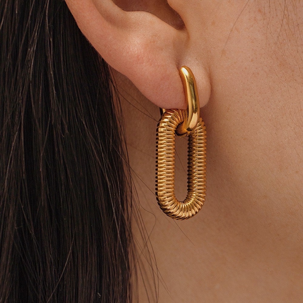 Elegant gold coil earrings, unique fashion accessory, luxury jewelry for women.