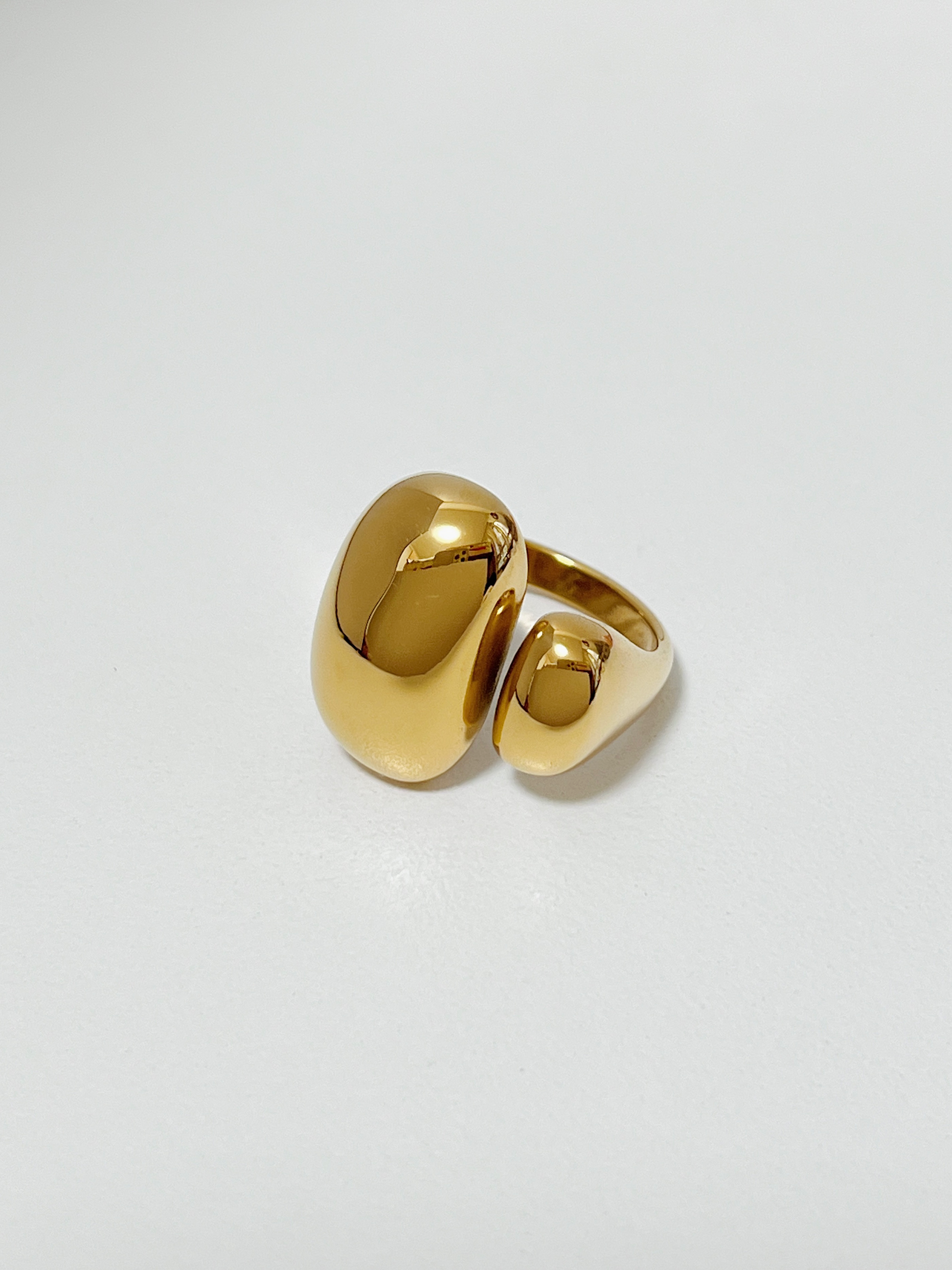 Gold chunky irregular ring on a light gray background