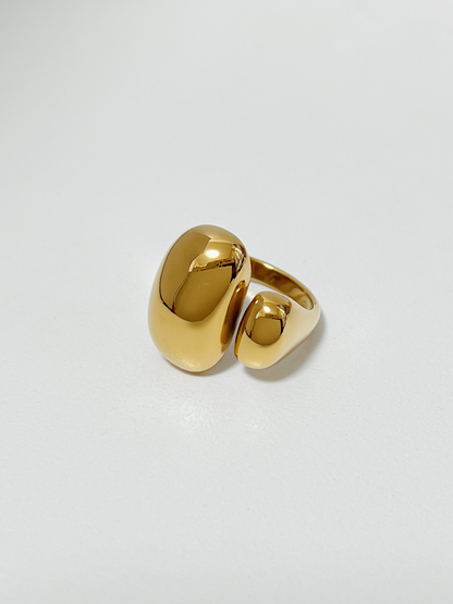 Gold chunky irregular ring on a light gray background