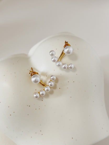 Pearl earring on a white surface