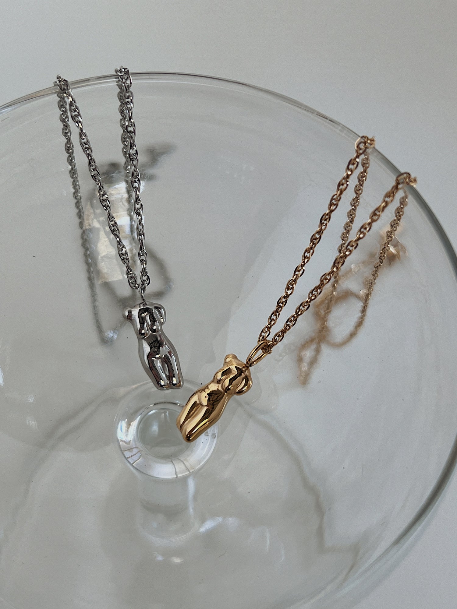 Minimalist pendant necklaces with a modern, sculptural design, a chic addition to any outfit.