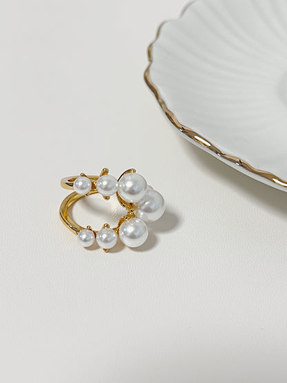 Gold ring with pearls on a light background