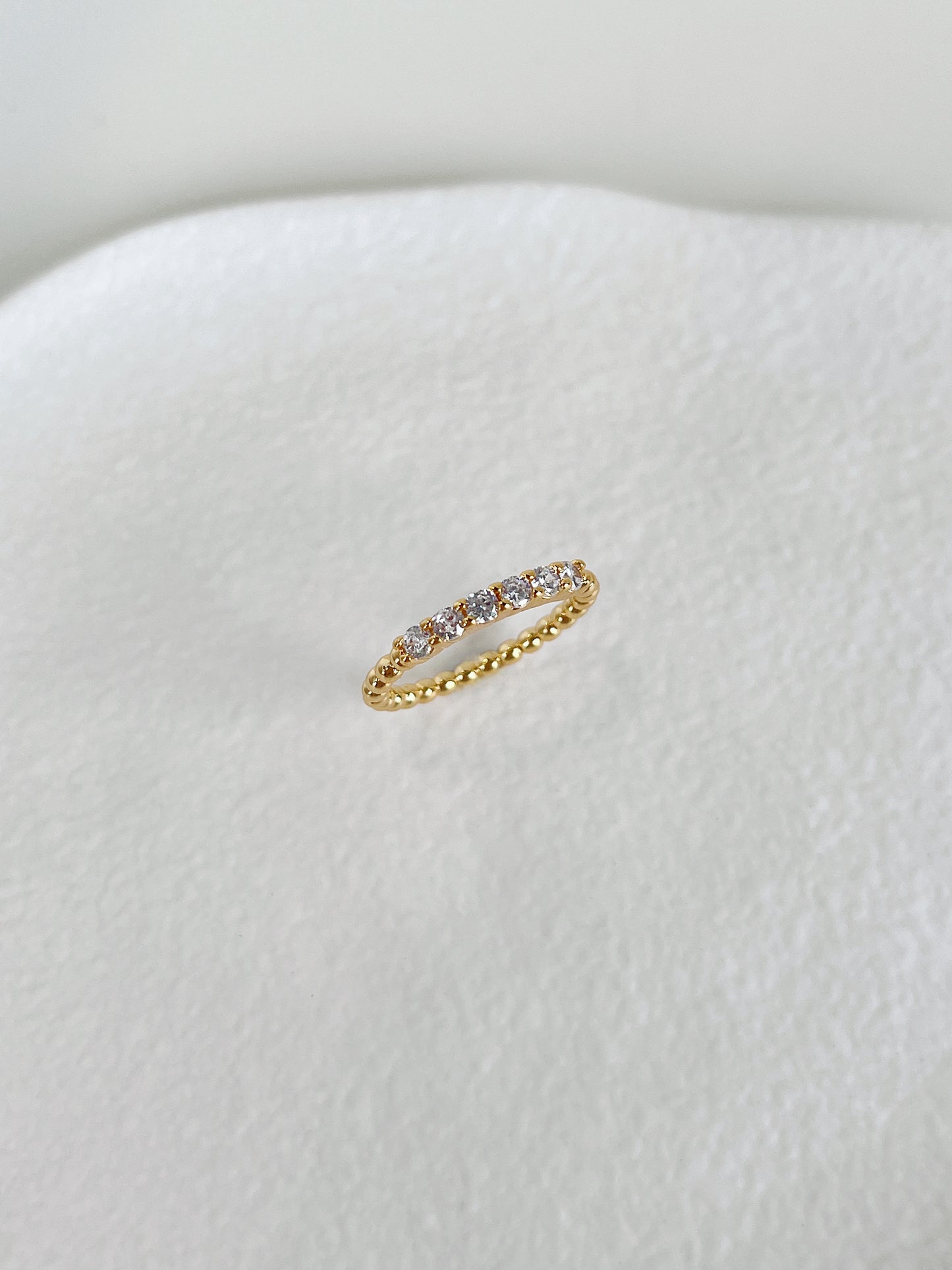Sleek flat profile 5A cubic zirconia beaded eternity band by Aurous Atelier