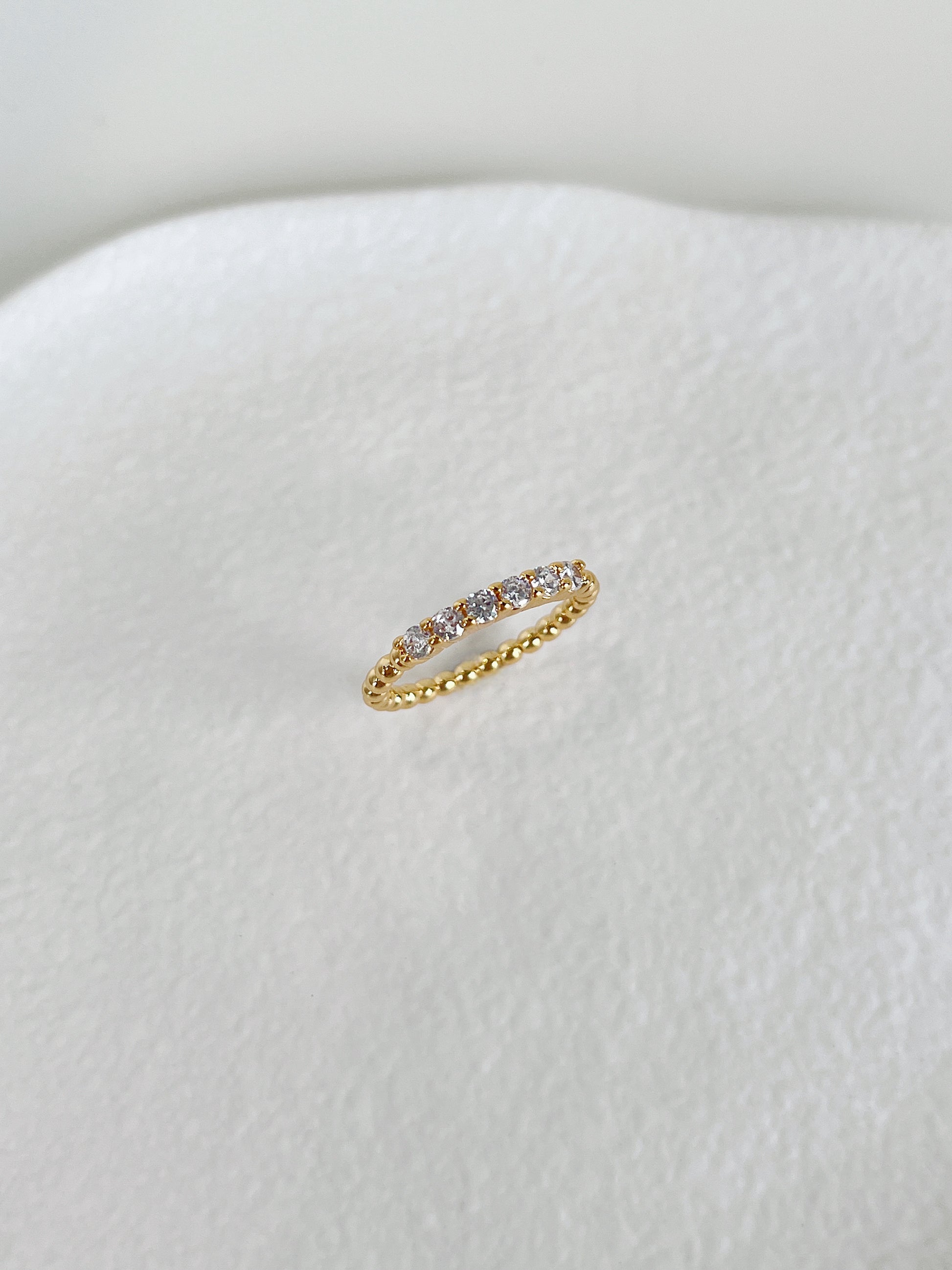 Sleek flat profile 5A cubic zirconia beaded eternity band by Aurous Atelier