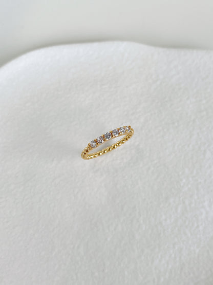 Sleek flat profile 5A cubic zirconia beaded eternity band by Aurous Atelier