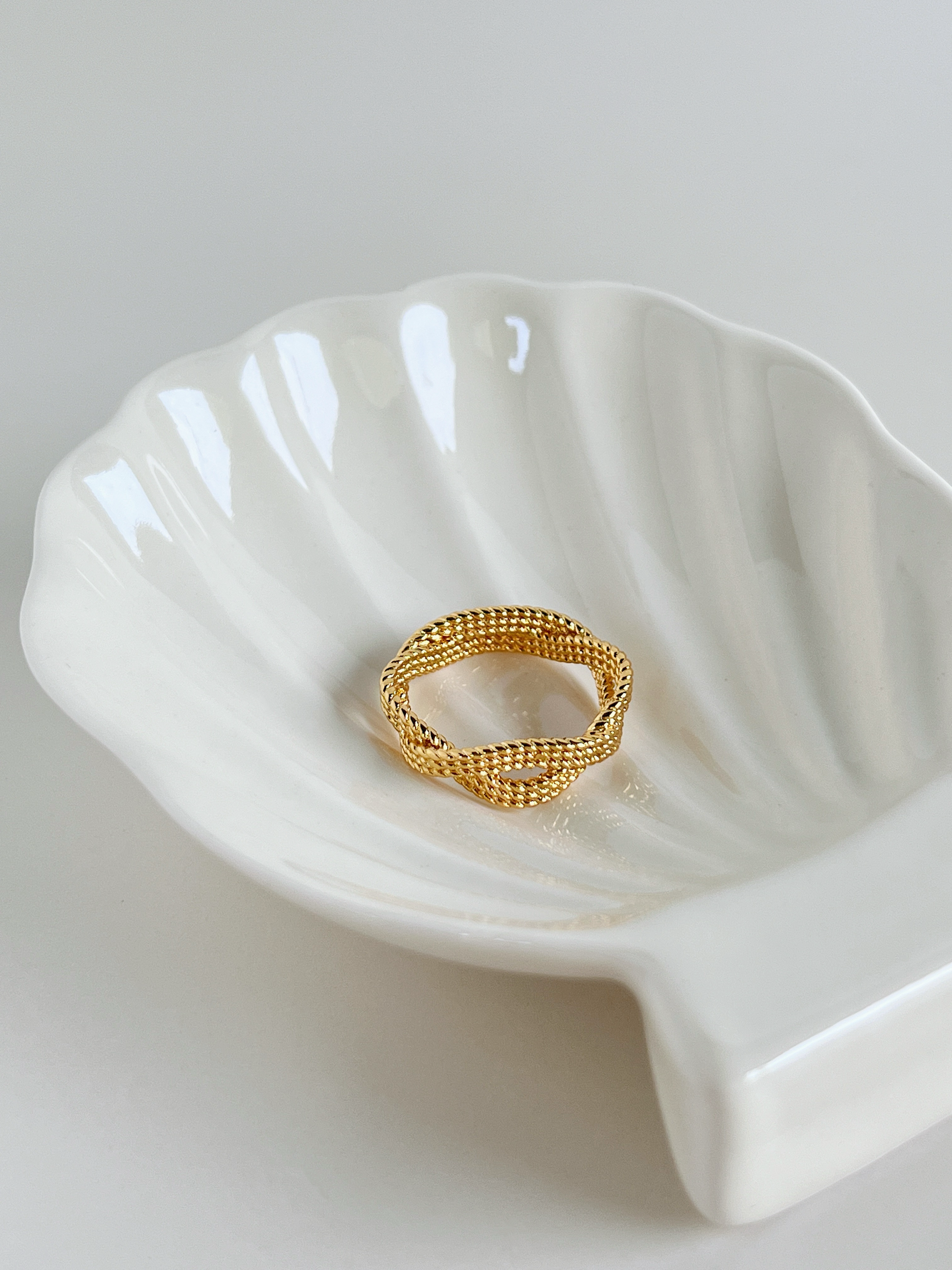 Intricate woven infinity braid ring with a modern brushed matte finish