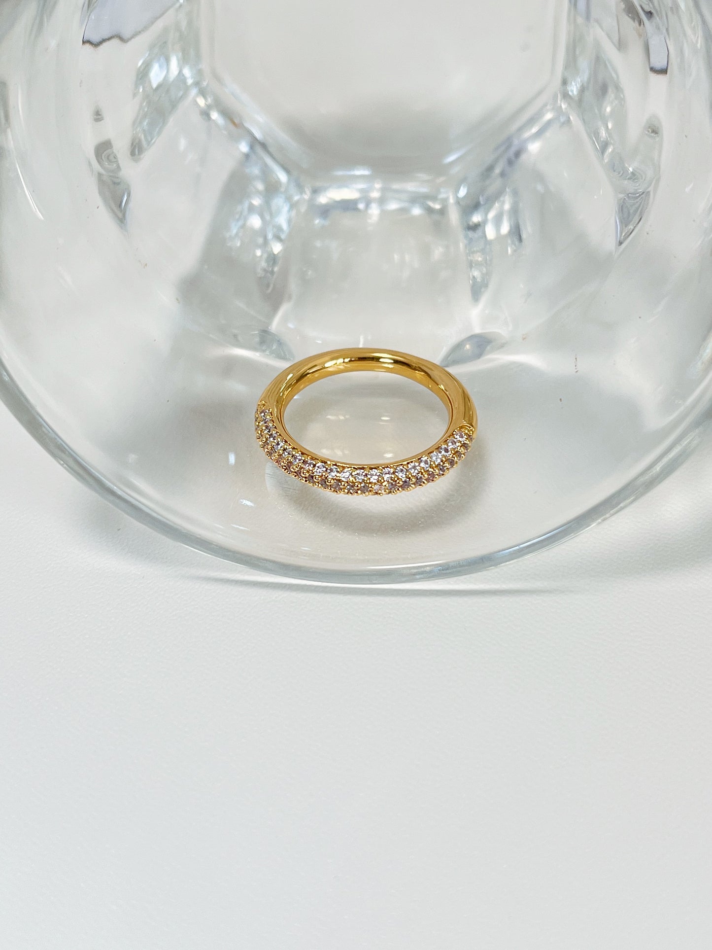 Gold half eternity ring with high shine mirror finish detail