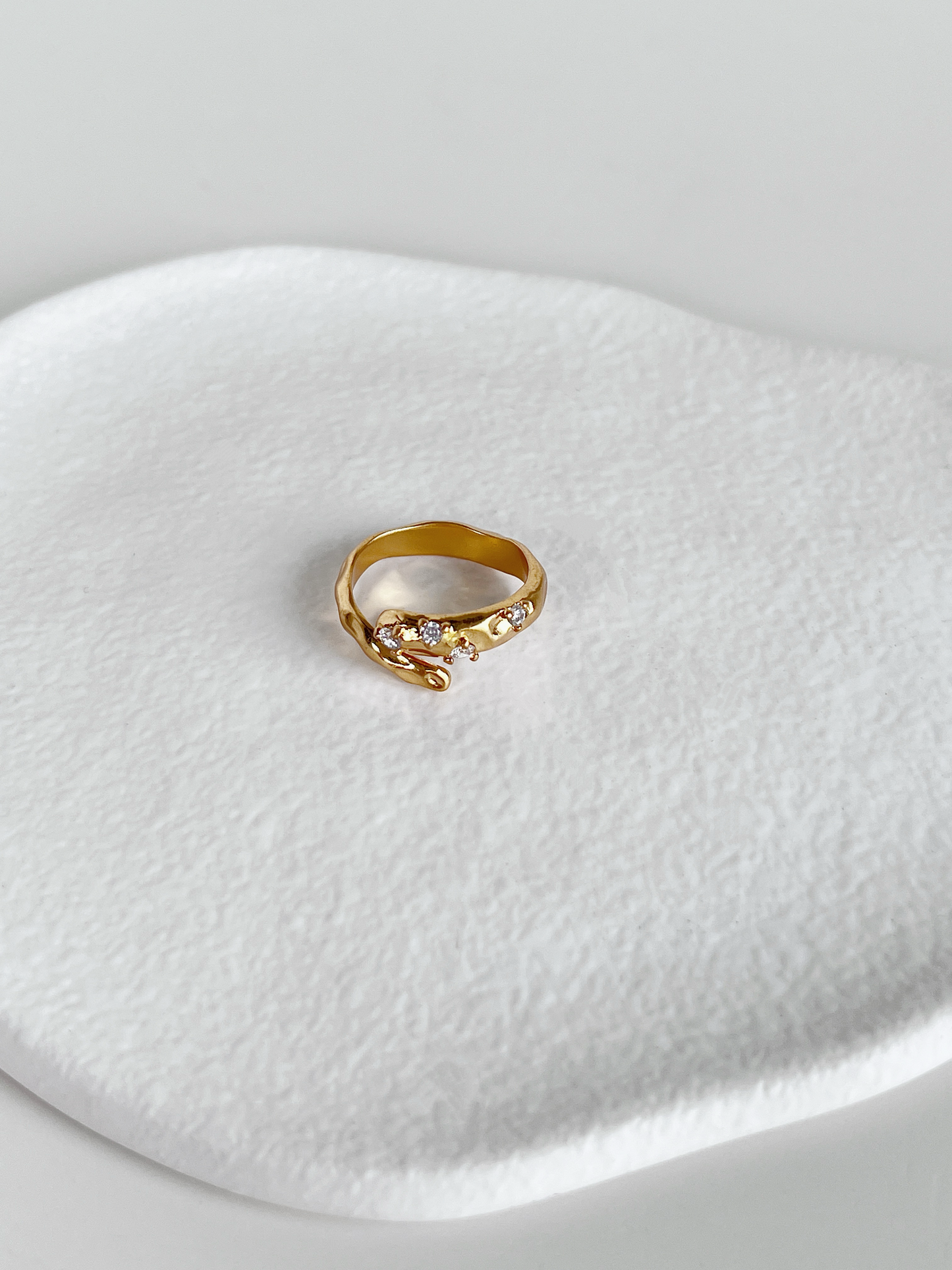 Gold hammered bypass ring with 5a grade cubic zirconia stone detail