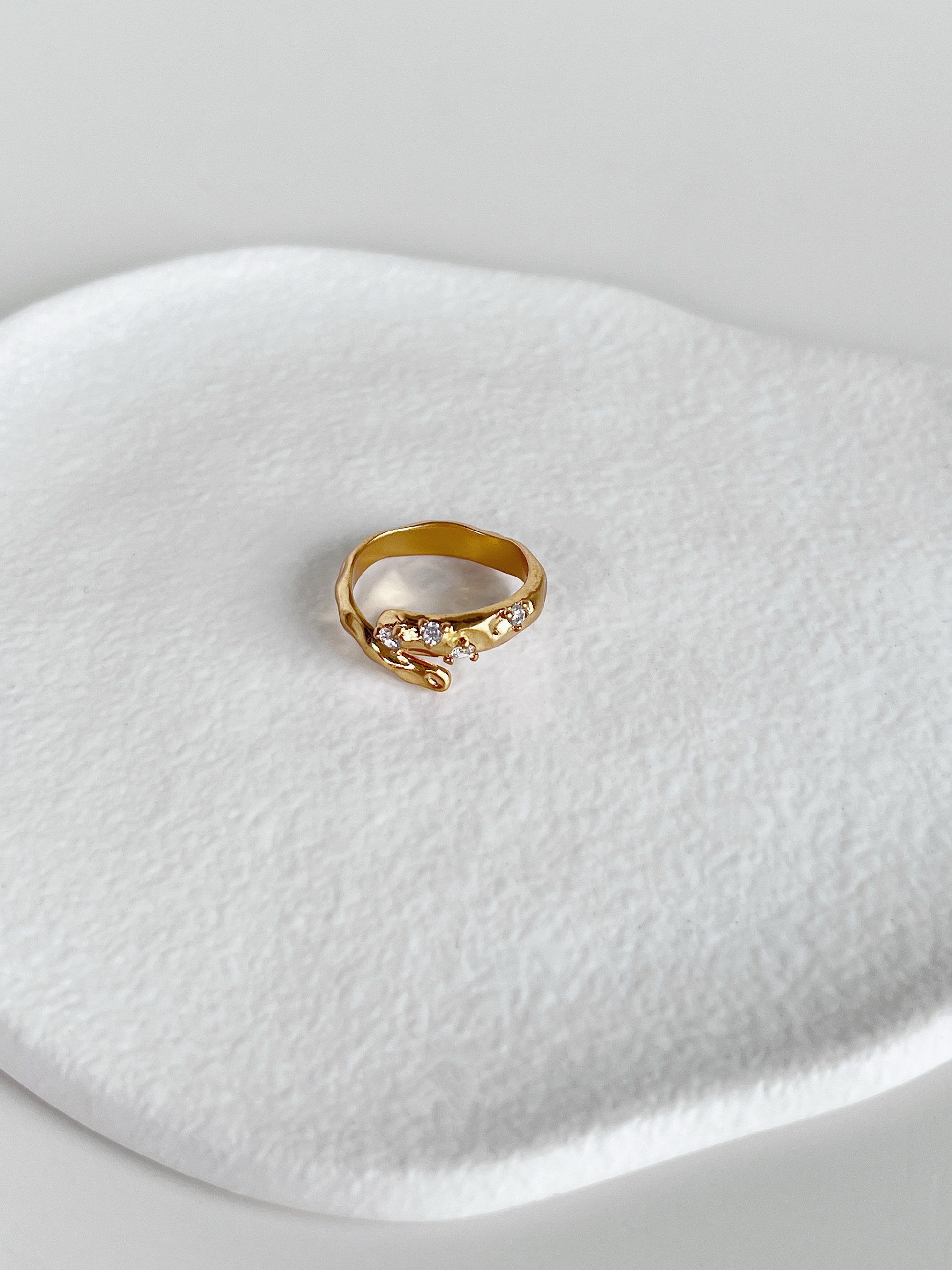 Gold hammered bypass ring with 5a grade cubic zirconia stone detail