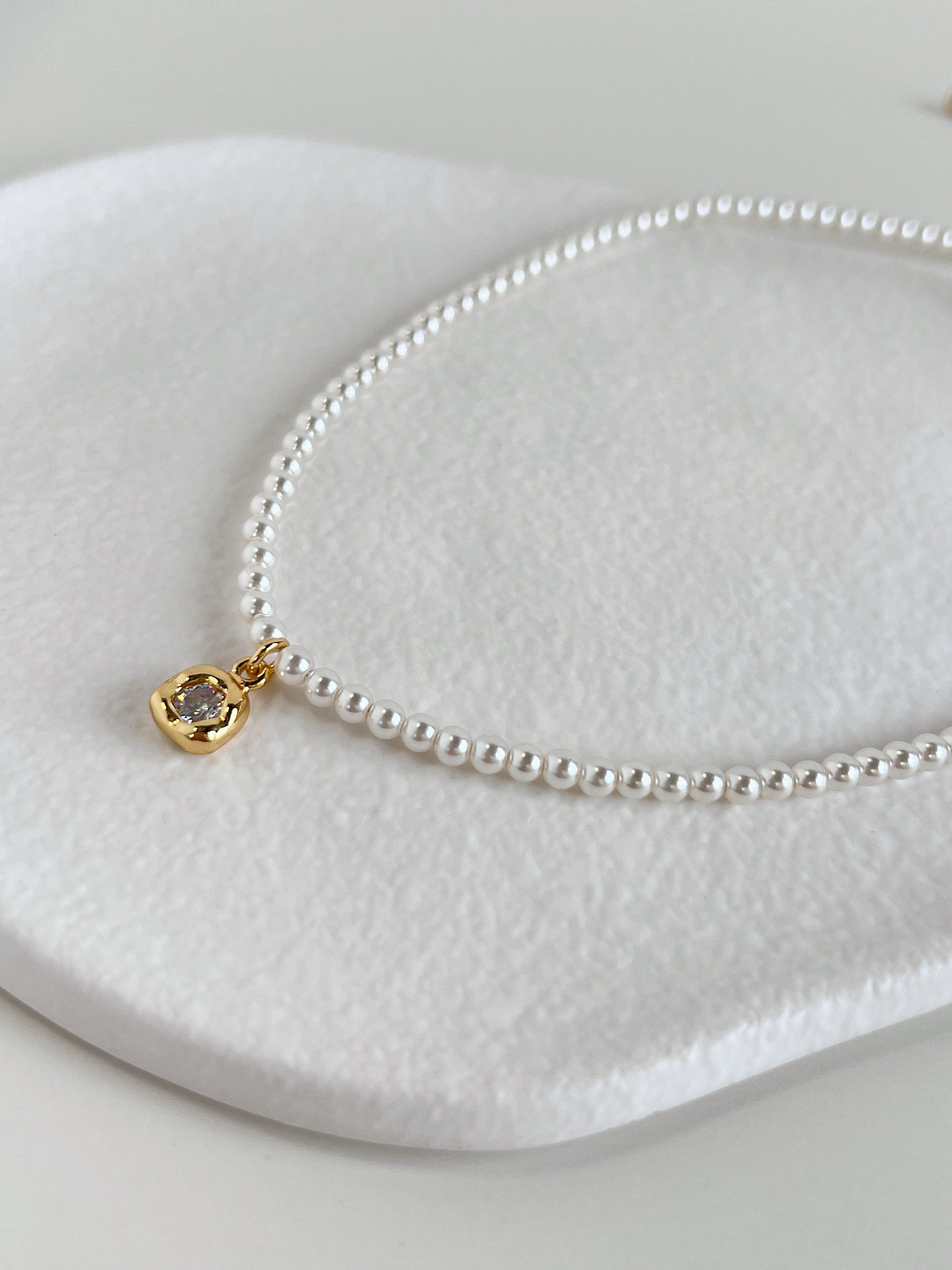 Detailed technical image focusing on the 18k gold PVD extender links and secure clasp of an artisan-crafted pearl necklet