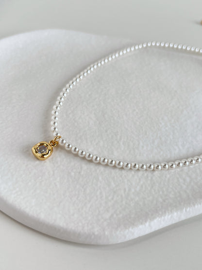 Detailed technical image focusing on the 18k gold PVD extender links and secure clasp of an artisan-crafted pearl necklet