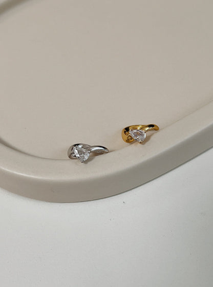 Close-up of Gold and Silver Teardrop Cuffs showing the pear-cut stone