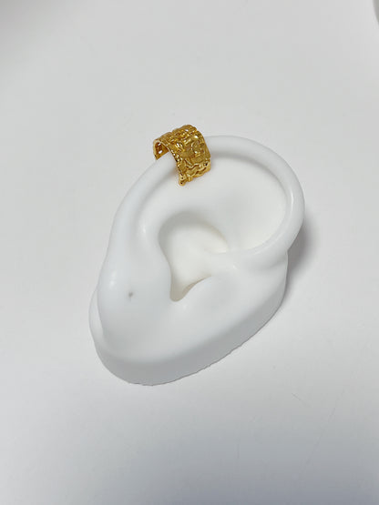 Close-up of white silicone ear featuring the 18k gold vermeil woven cuff.