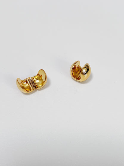 Pair of gold hoop earrings on a light gray background