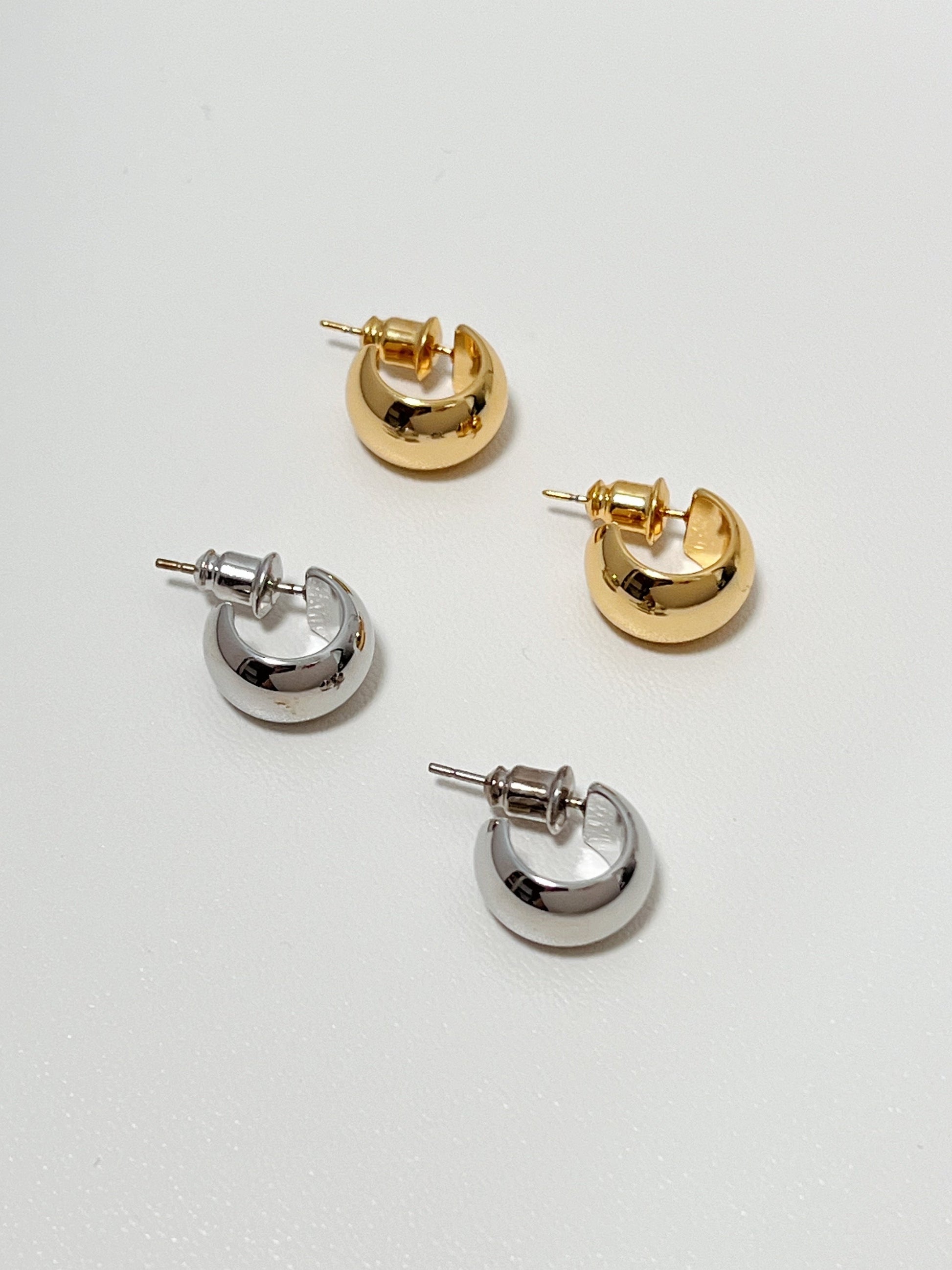 Stylish gold and silver-toned huggie hoop earrings, perfect for everyday wear and accessorizing.