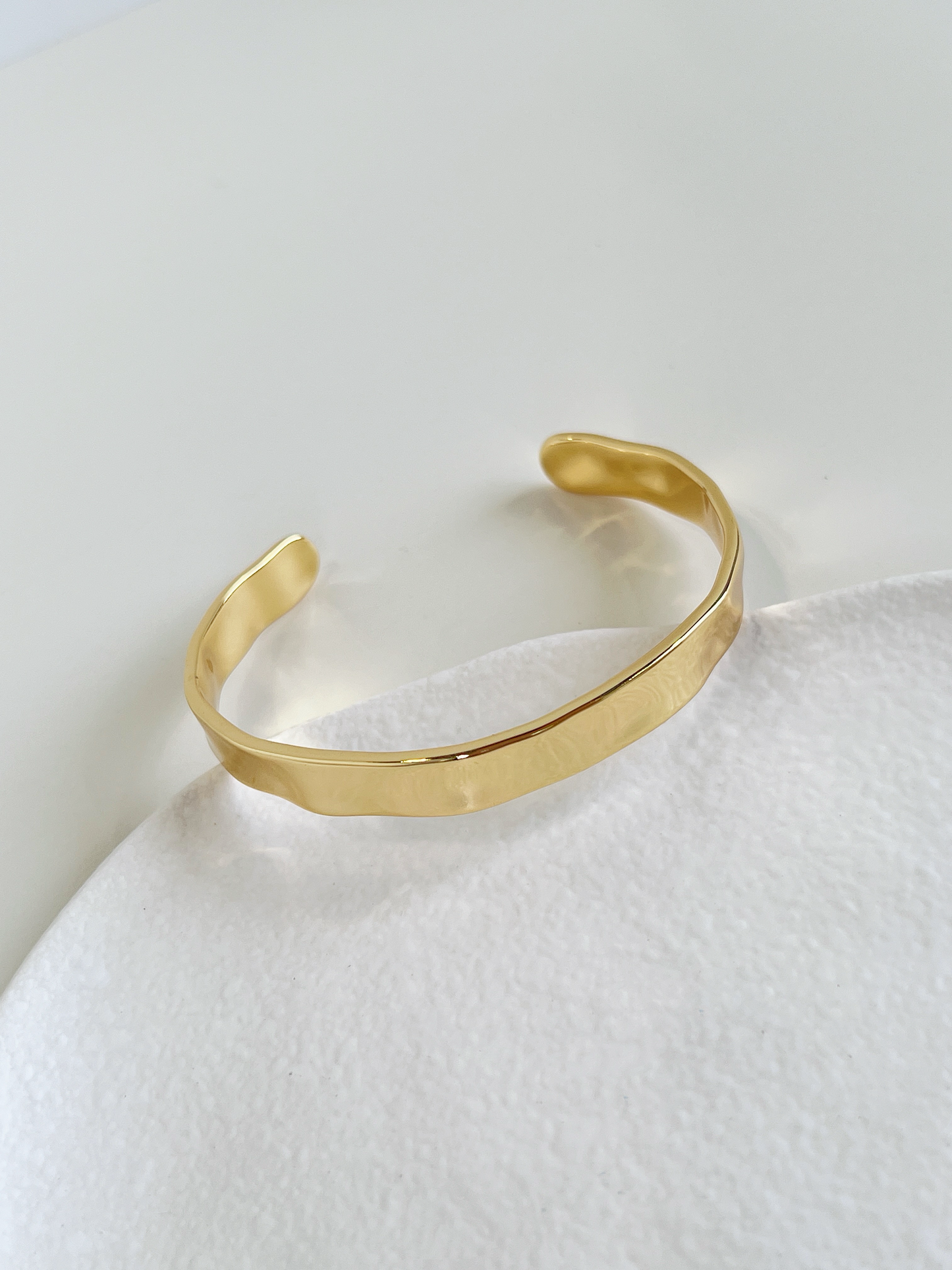 Timeless gold-tone cuff bangle, a classic and versatile jewelry piece.