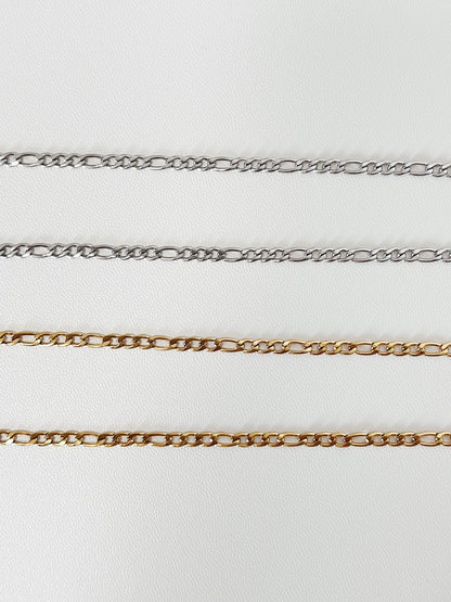 Four gold figaro chains on a white background