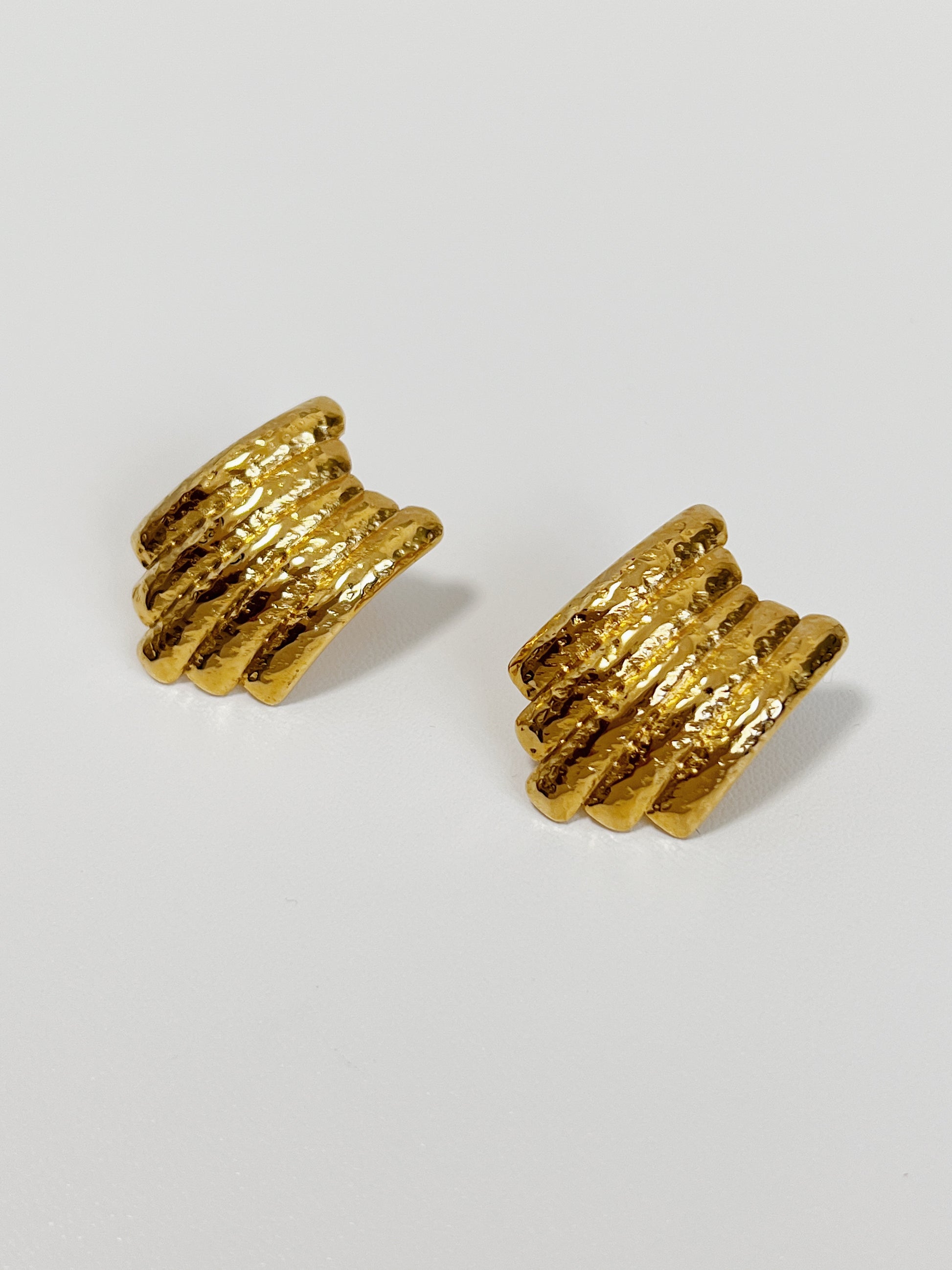 Elegant gold earrings with a multi-layered hammered finish.