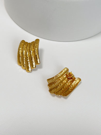 Chic gold earrings with a multi-layered hammered texture.