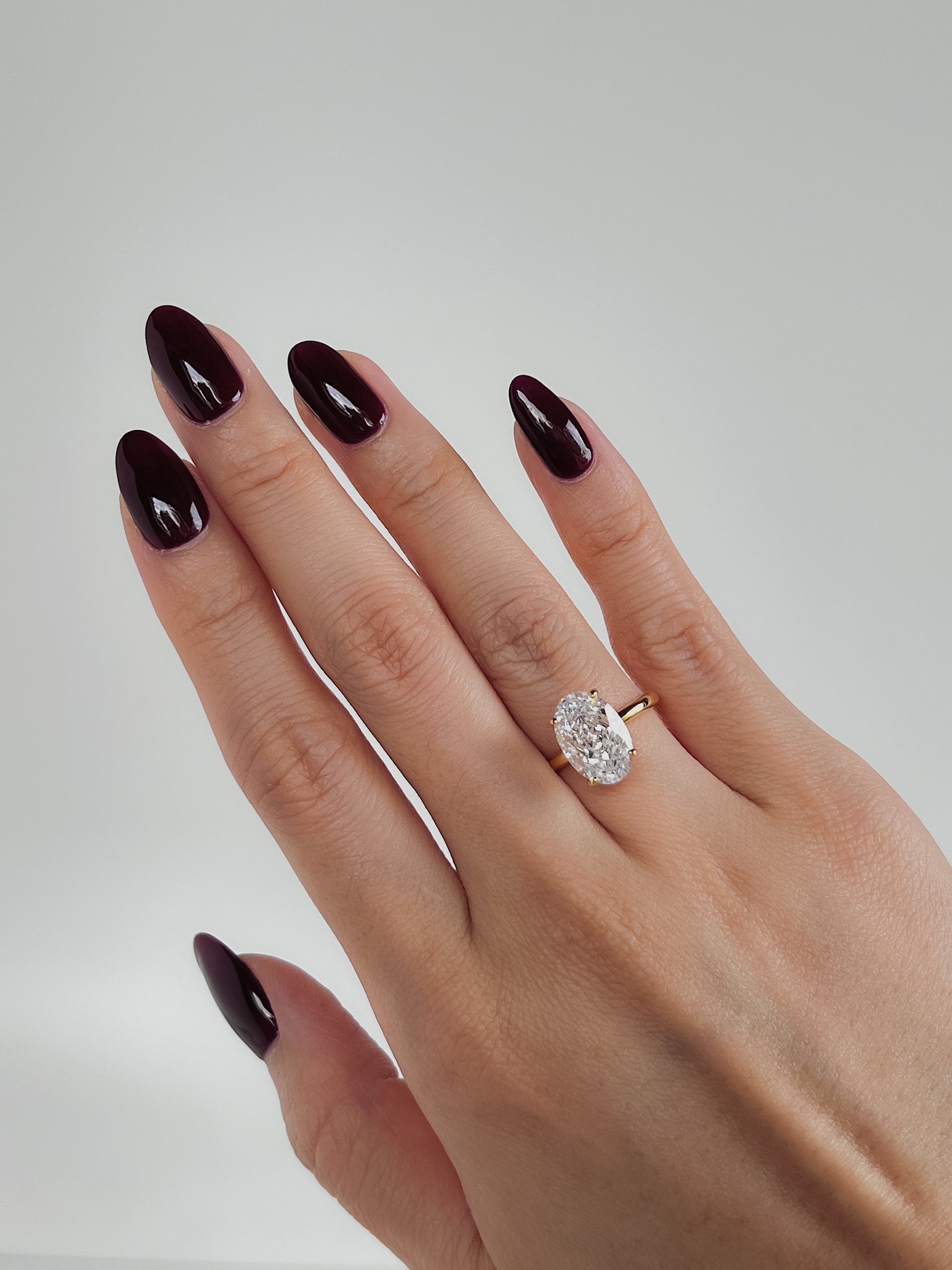 Minimalist everyday styling with a 3ct oval diamond alternative ring