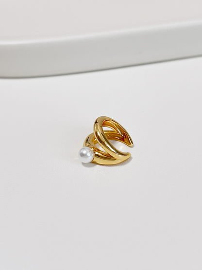 Gold double band ear cuff with a pearl on a white background