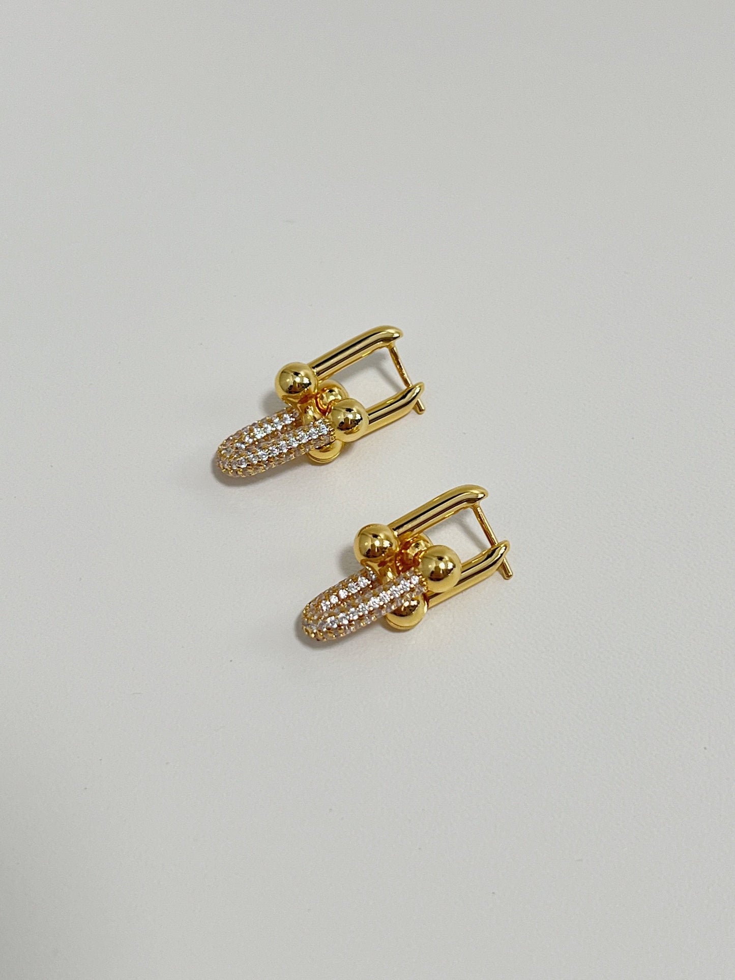 elegant gold earrings with diamond embellishments and statement link design.