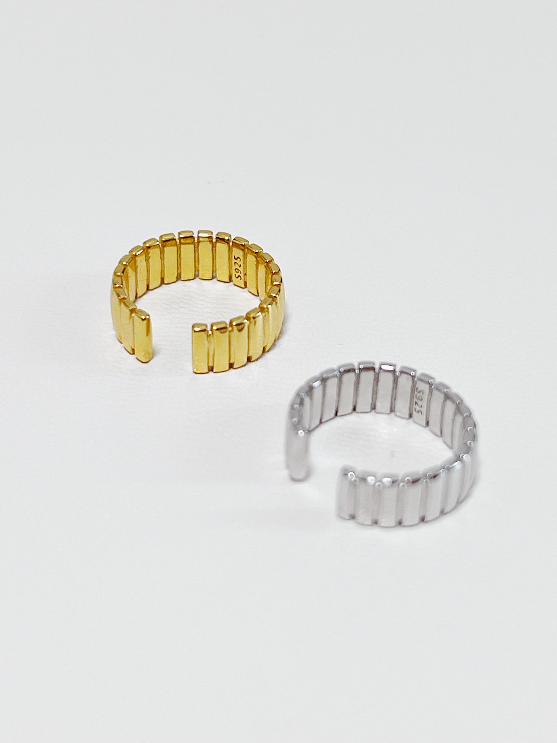 Gold and silver sterling silver ear cuff on a white background