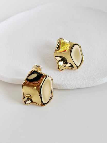 Gold bold clip on earrings on a white background