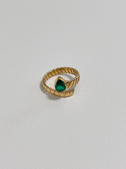 Unique gold ring with emerald teardrop, ideal for luxury jewelry lovers and collectors.