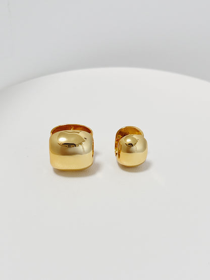 Pair of gold hoop earrings on a white background