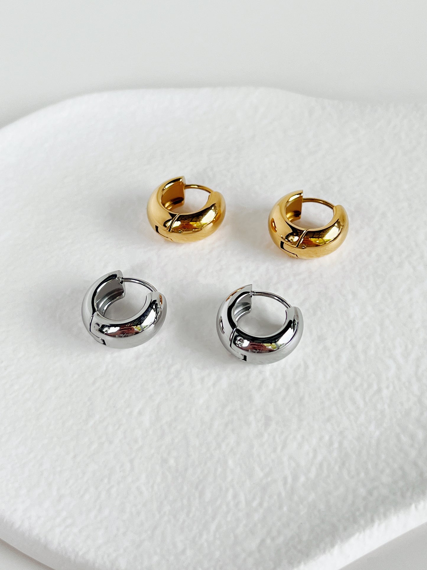 Flat lay of Amie gold and silver hoops for comparison.