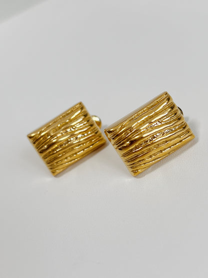 Stylish textured gold earrings, rectangular shape.