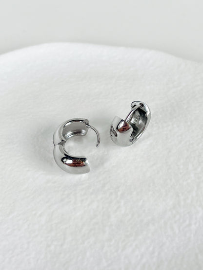 Pair of silver hoop earrings on a white background