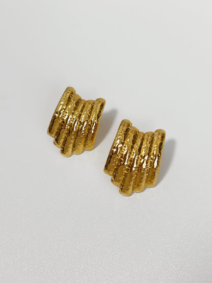 Gold earrings with a unique ribbed and hammered texture.