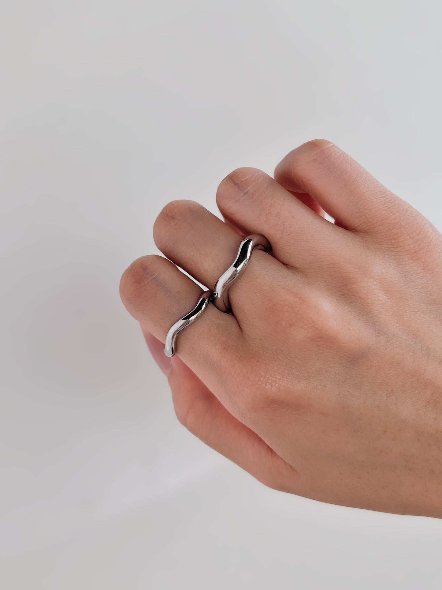 Minimalist silver wave ring, sleek, on finger