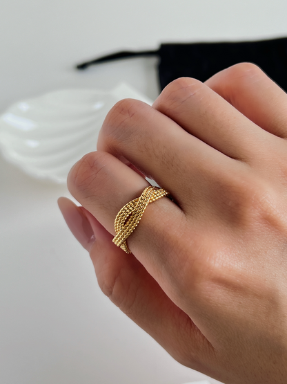 Elegant gold ring with a sophisticated and intricate rope twist.