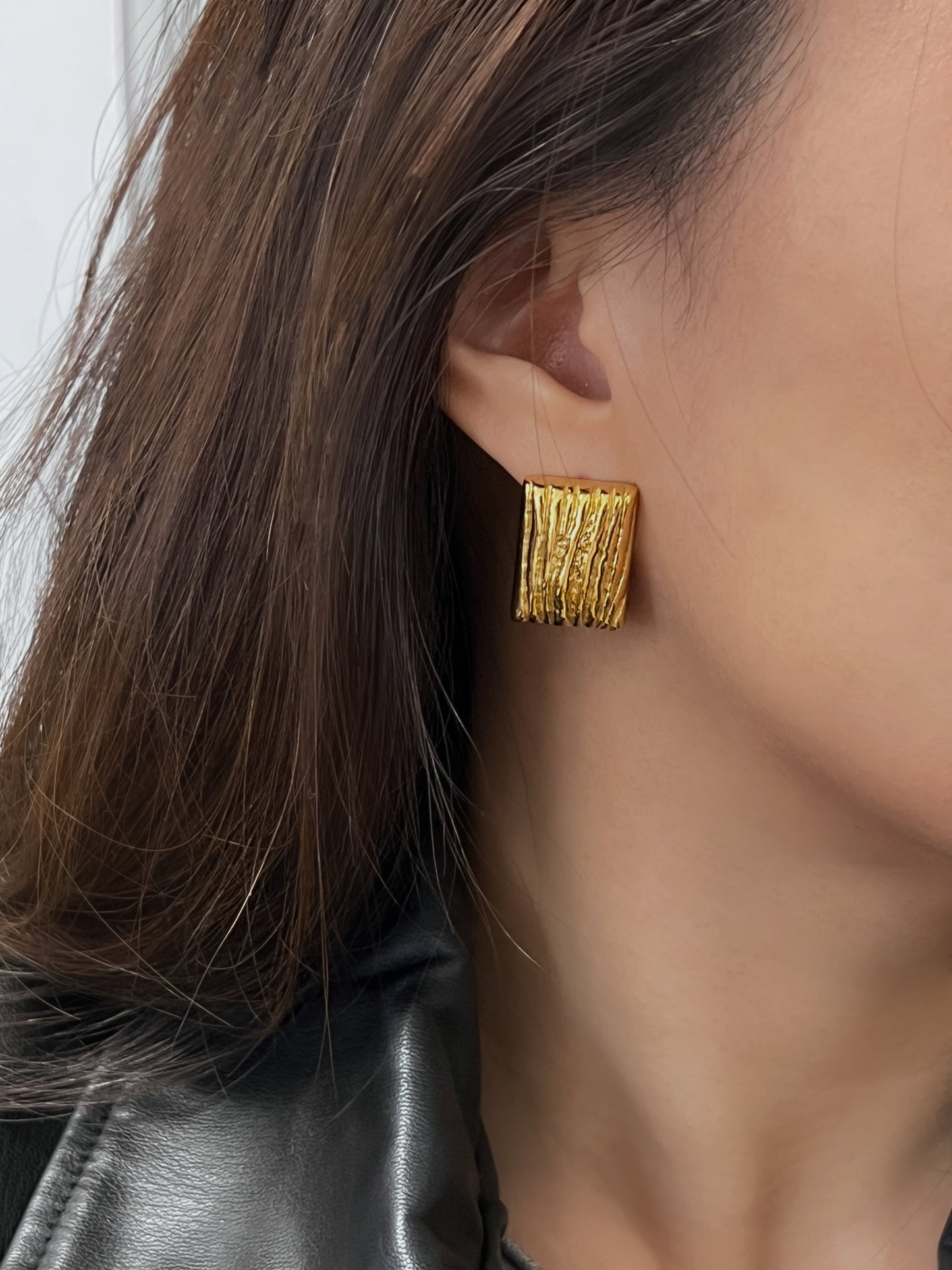 Gold rectangular textured earrings for women.