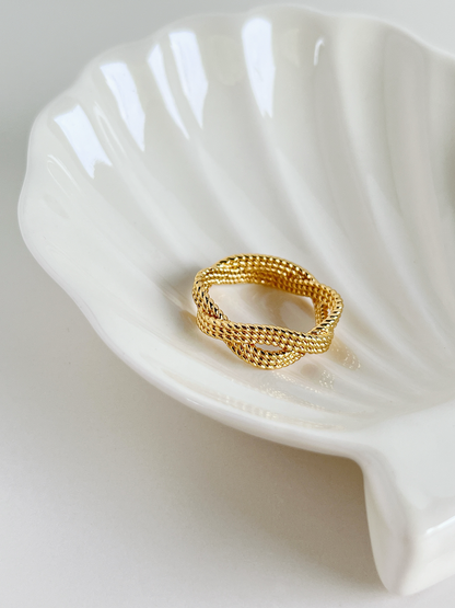 Fashionable gold ring with a distinctive twisted rope pattern.