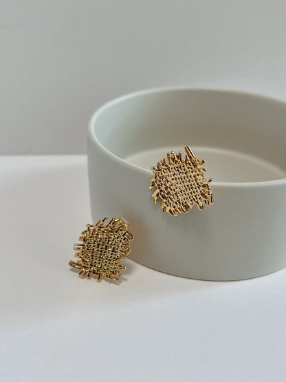 Front view showing lightweight hollow cast structure of gold woven clip-on