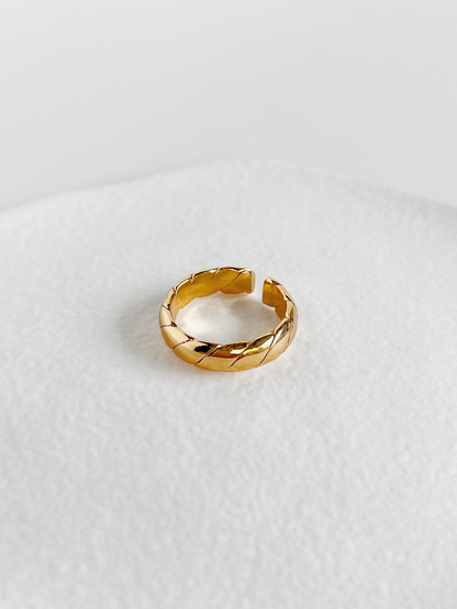 Polene gold twill high shine ring macro shot highlighting the uniform diagonal twisted channels