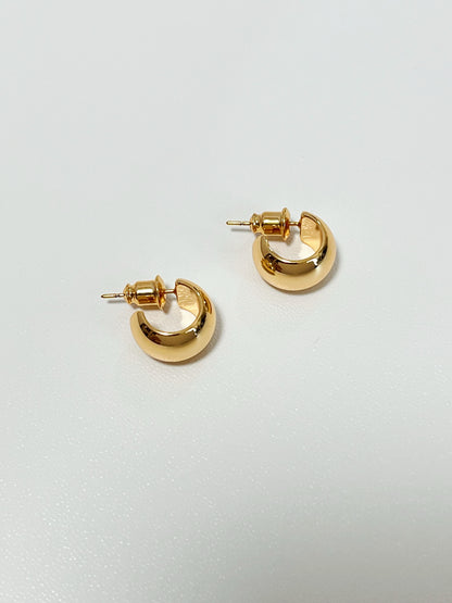 Fashionable gold huggie hoop earrings with a sleek and minimalist design.