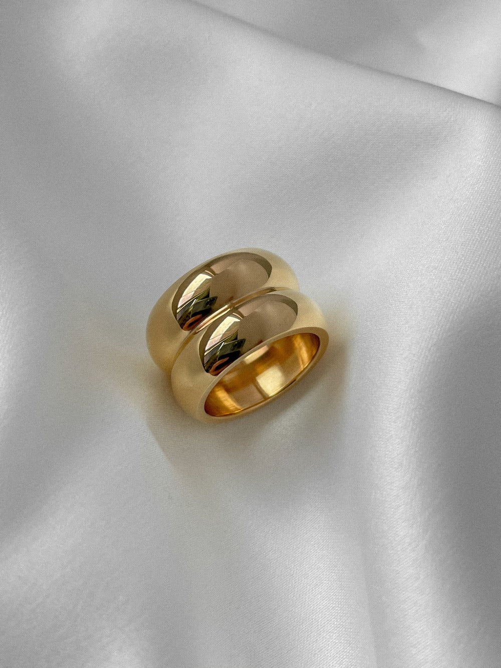 Elegant gold cigar band ring for women, stylish statement jewelry piece.